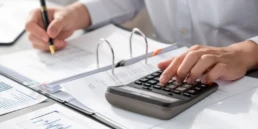 corporate auditor calculating budget with calculator his office desk dedicated accountant professional accounting business company analyzing financial document forecast income insight